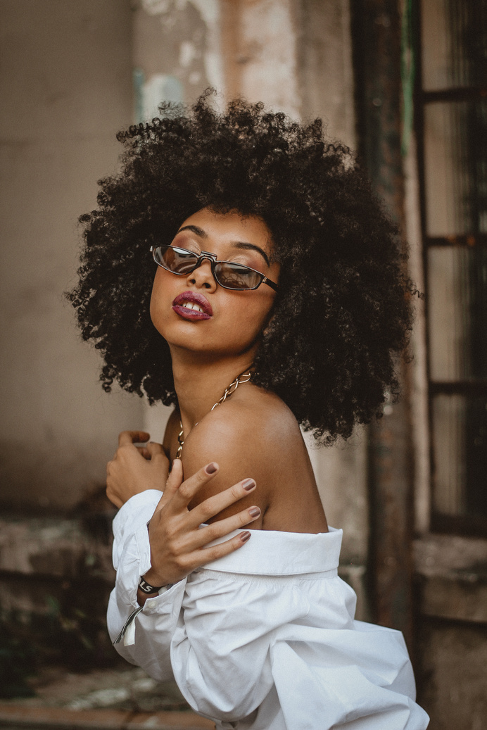 Portrait of Woman with Curly Hair and Sunglasses